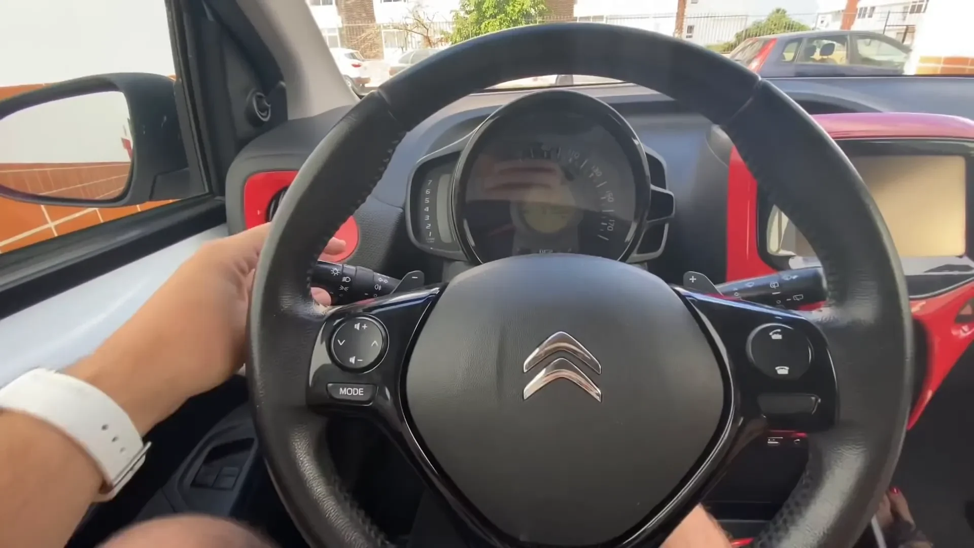 Adjusting mirrors and checking dashboard controls